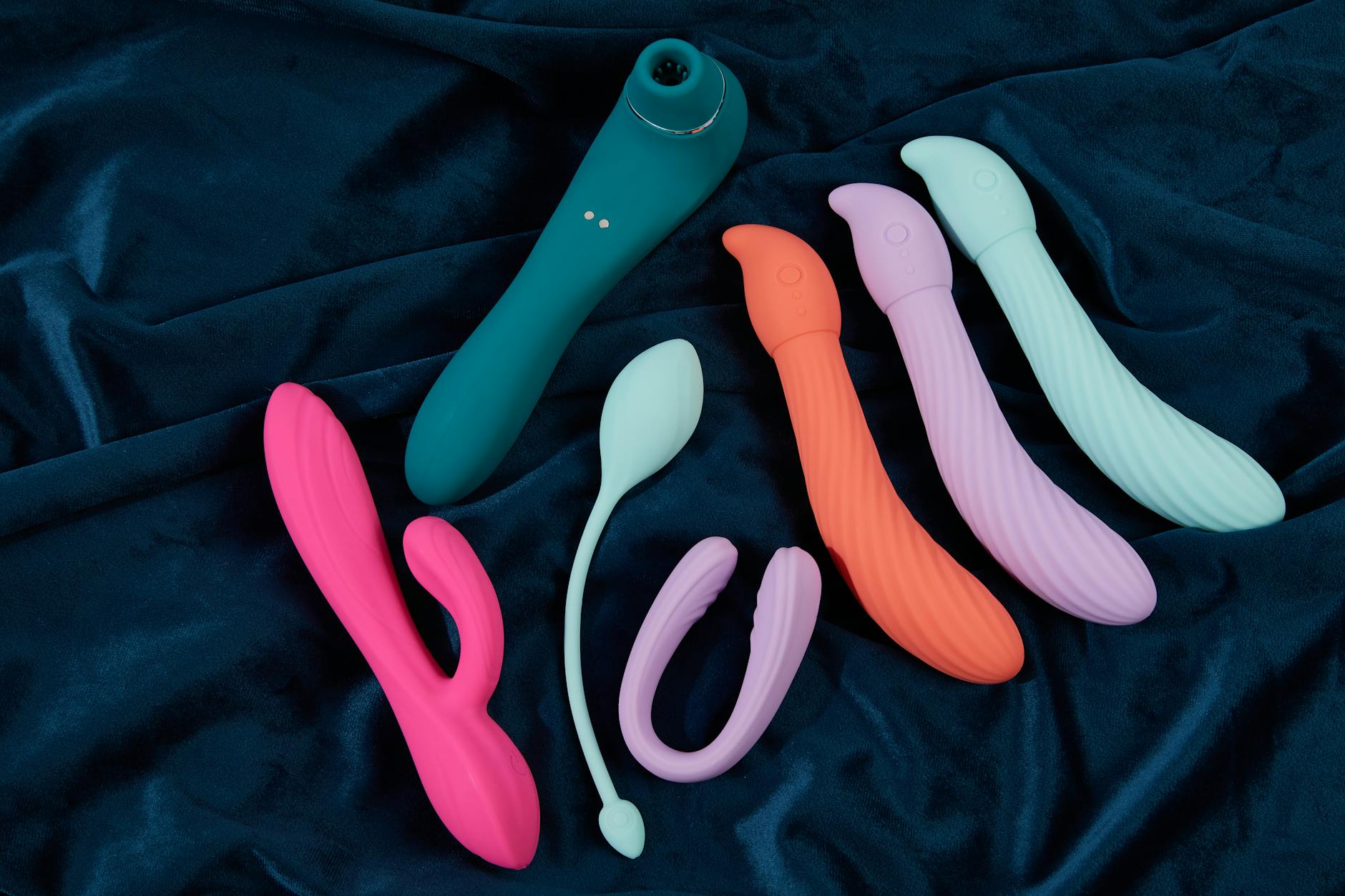 A couple standing close together indoors, exploring intimacy with a vibrator