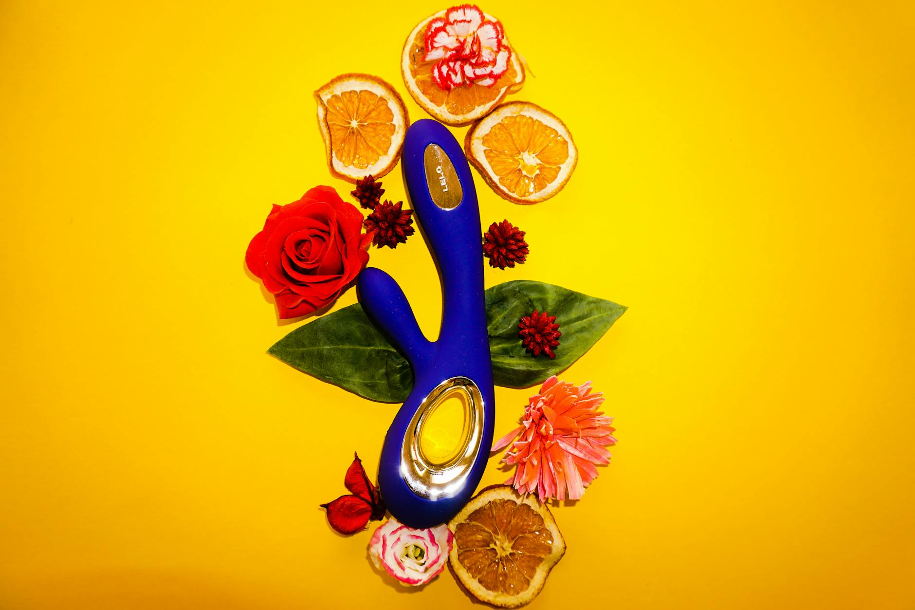 Close-up of hands holding a sleek blue vibrator, demonstrating intimate touch and modern sensuality.