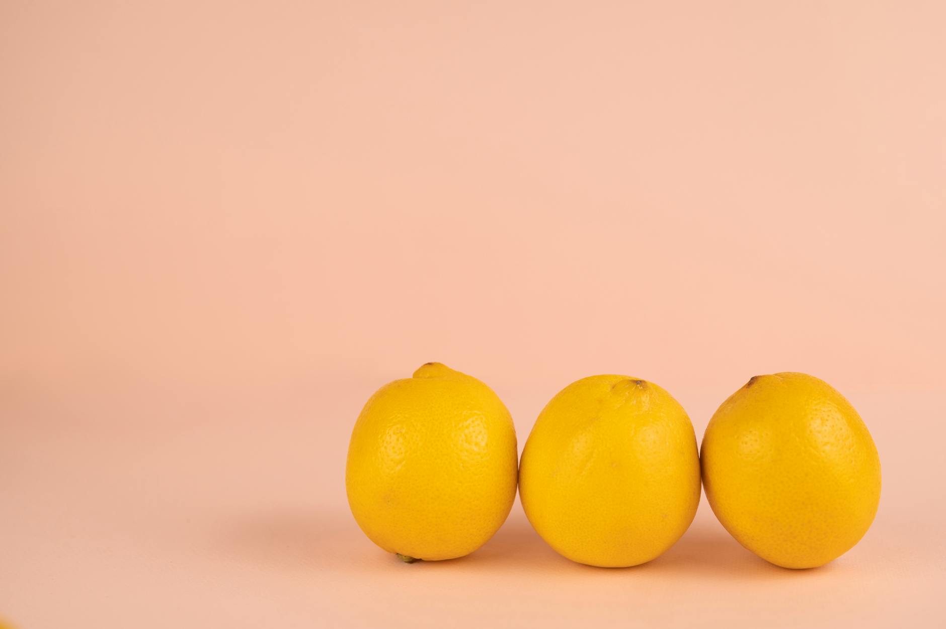 Ripe lemons arranged on a soft pastel background, symbolizing the precision and control of lemon vibrators