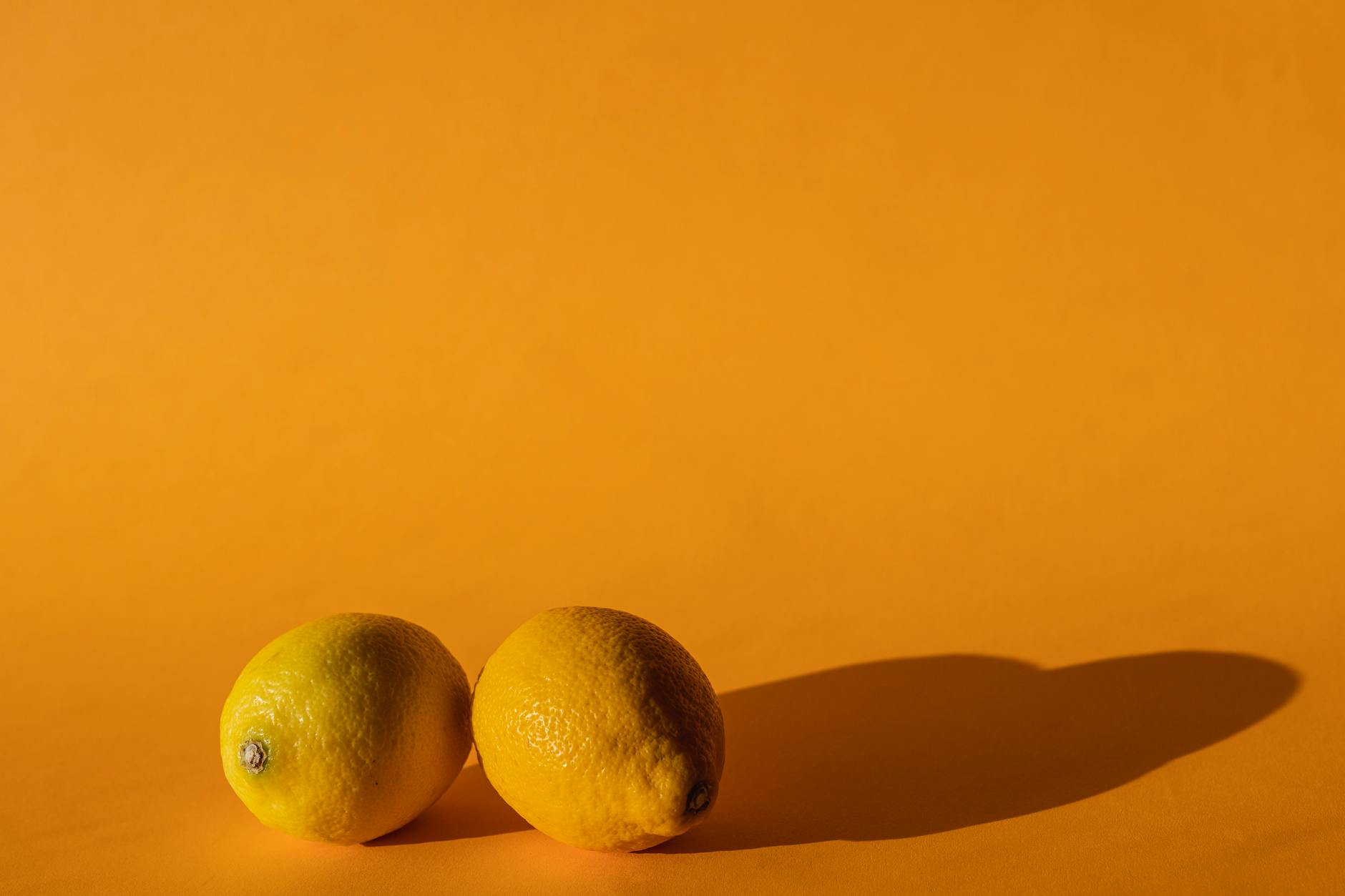 Two people smiling with lemon slices, expressing joy and confidence in sensuality